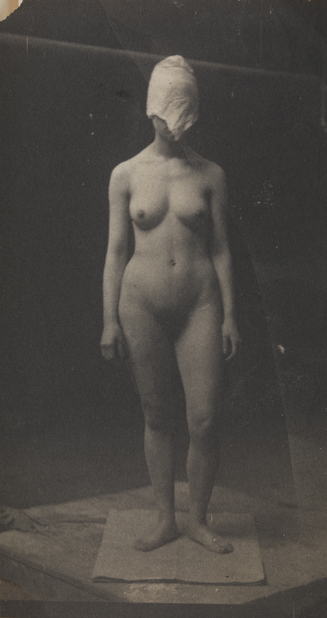 Female nude with mask, left leg bent
