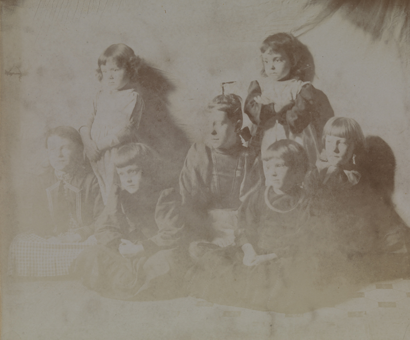 Unidentified woman with six unidentified children