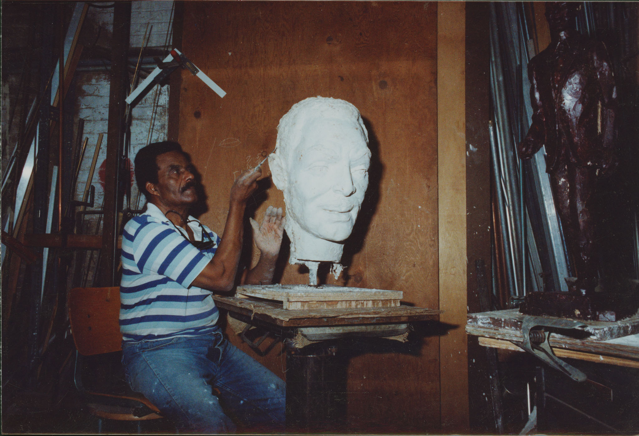 An artist sculpting a head.