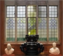 KAWS, interior view with BORN TO BEND seen through stained glass window in Washington Foyer, Historic Landmark Building, PAFA