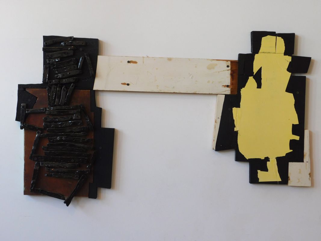 Kate Moran, ceramic 'logs', wood painted black, offwhite, yellow with an unpainted section the color of rust, woods screws its natural color of rust, wood screws, H 23'x W 40'x D 1', 2018