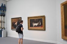 student looking at museum painting