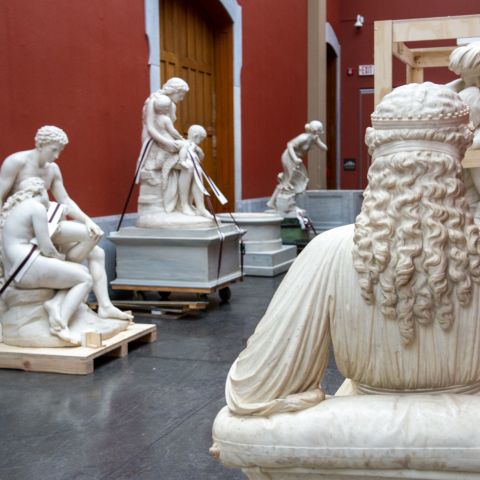 marble statues on wood pallets