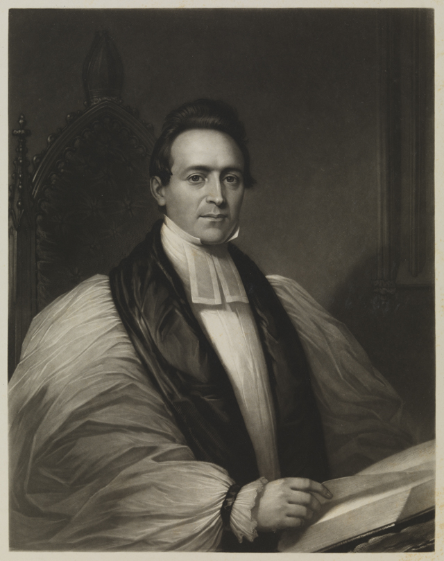 [Minister - seated, turning page of book]