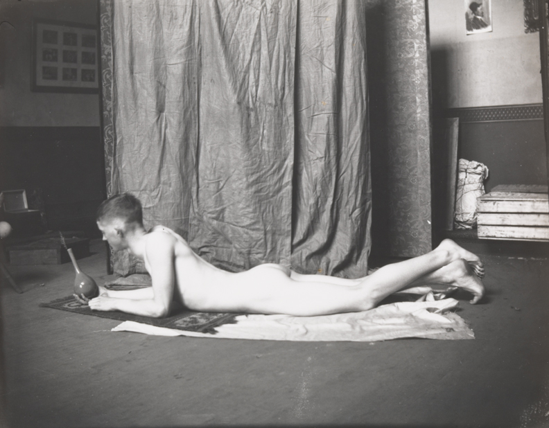 Bill Duckett nude, lying on stomach, holding  vase