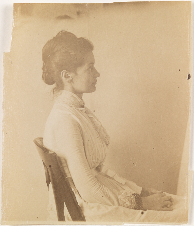 Mary Macdowell in light dress, sitting, facing right