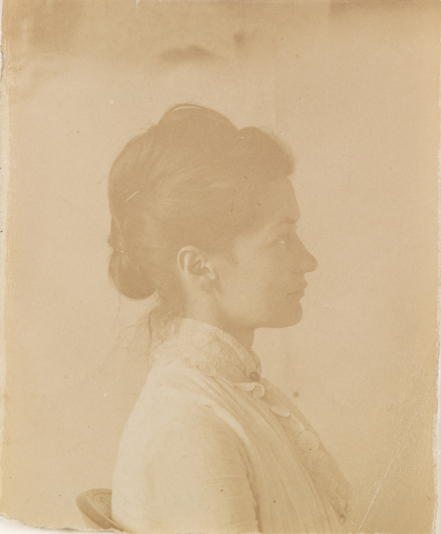 Mary Macdowell in light dress, sitting, facing right