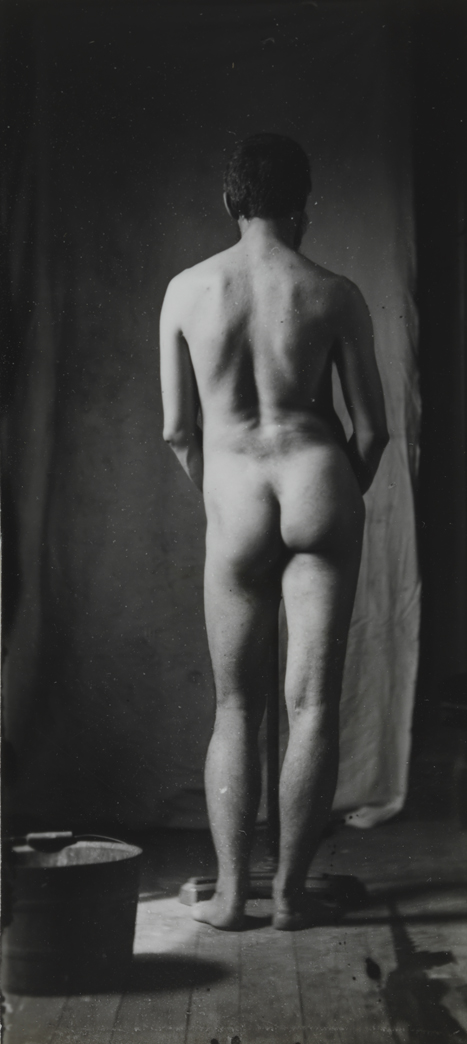 Naked series: Thomas Eakins with chair in front of cloth backdrop, pose 7