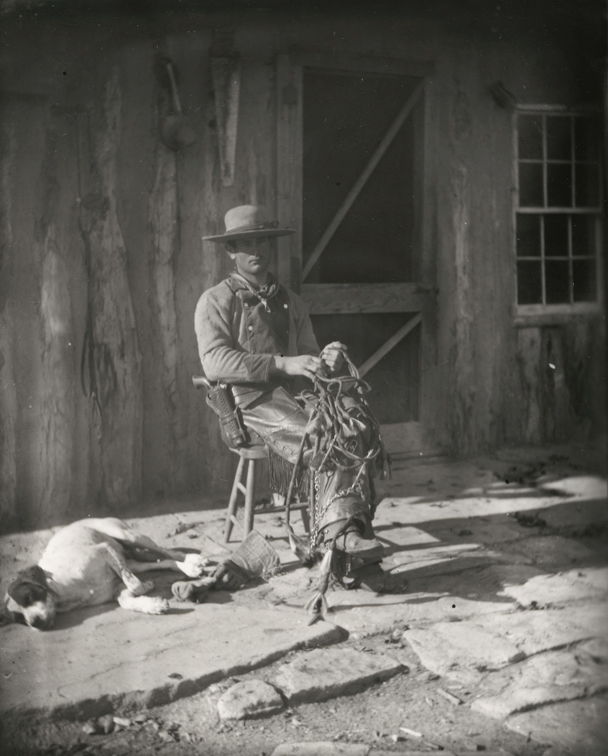Cowboy sitting in front of BT Ranch building