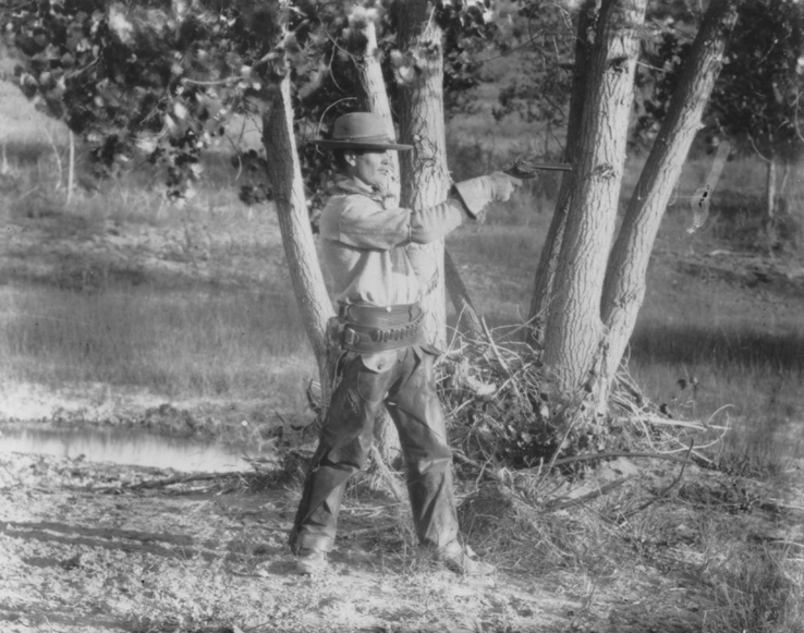 Cowboy aiming a revolver