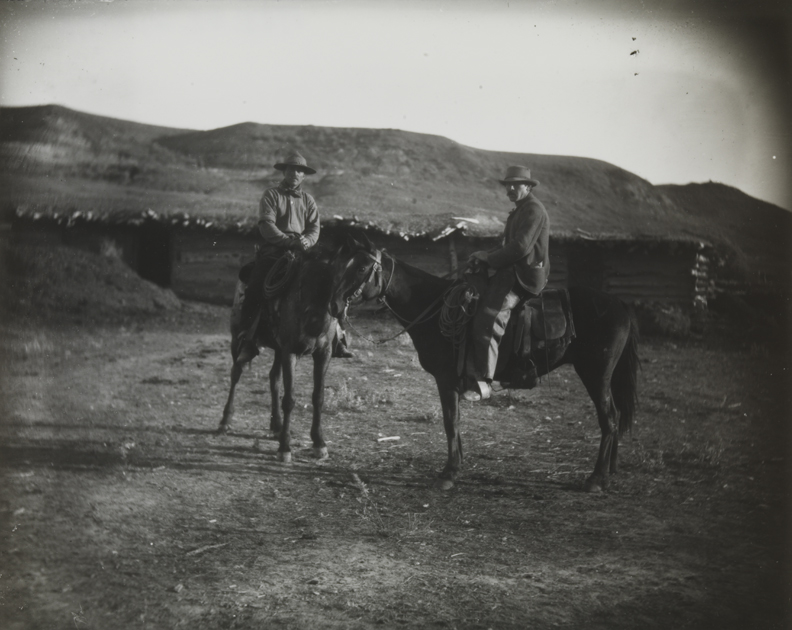 Two cowboys on dark horses at BT Ranch