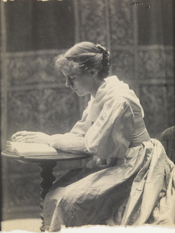 Eva Watson, reading at small round table