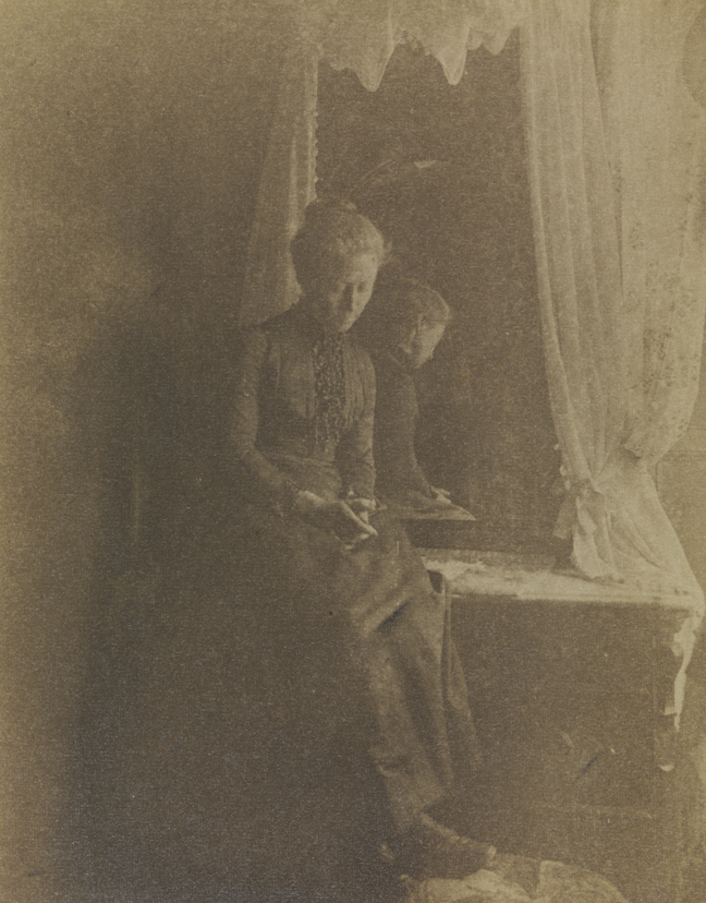 Unidentified woman sitting on mirrored dressing table