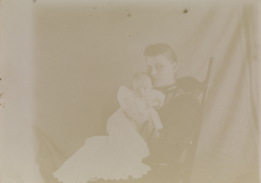 Unidentified woman and infant in rocking chair