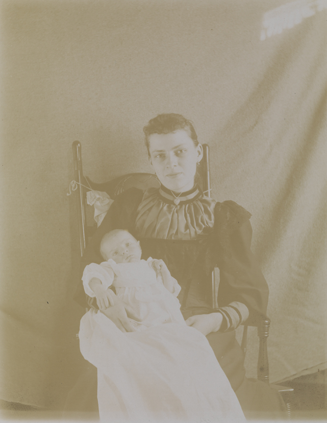 Unidentified woman and infant in rocking chair
