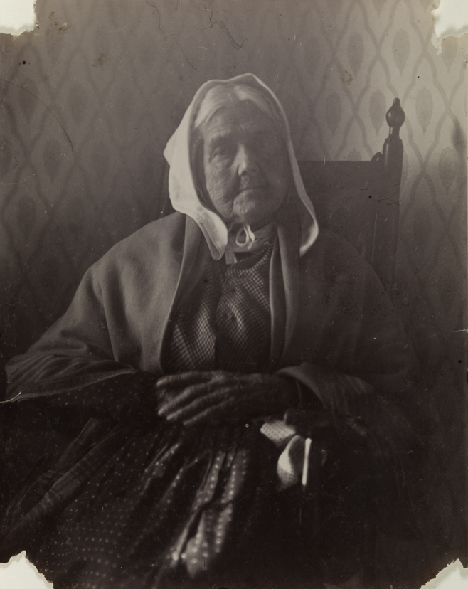 Old woman with white kerchief, sitting