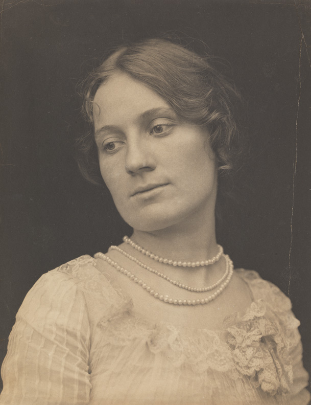 Unidentified woman, wearing pearl necklace, looking left