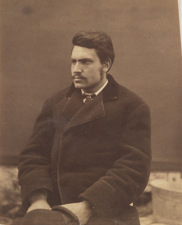 Unidentified man sitting, facing left