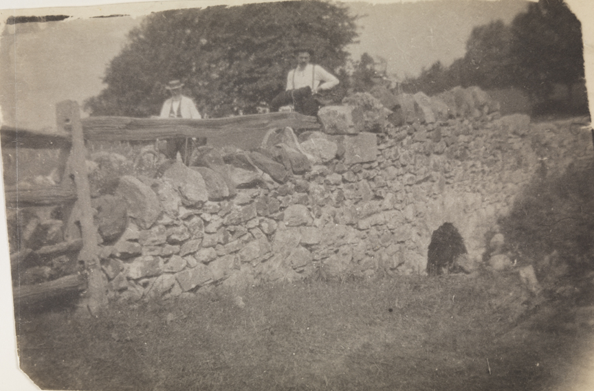 Benjamin Eakins and Samuel Murray with bicycles on stone bridge                     