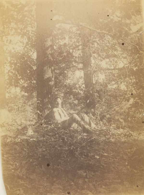 Samuel Murray (?) sitting in woods