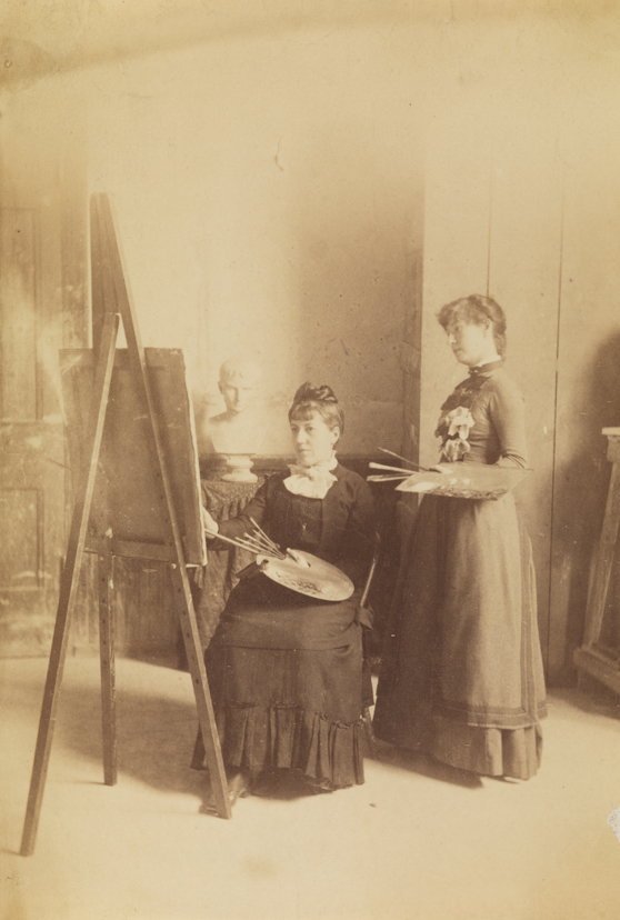 Two female students in Pennsylvania Academy studio with palettes and easel