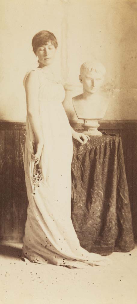 Woman in classical costume, holding flowers, with bust of Caesar