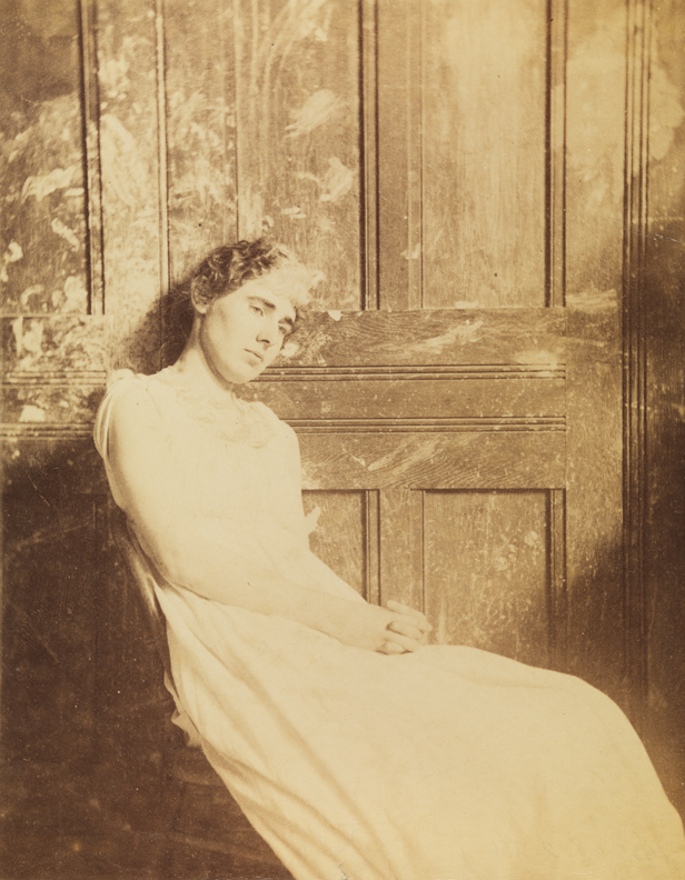 Woman sitting, head against studio door in Pennsylvania Academy