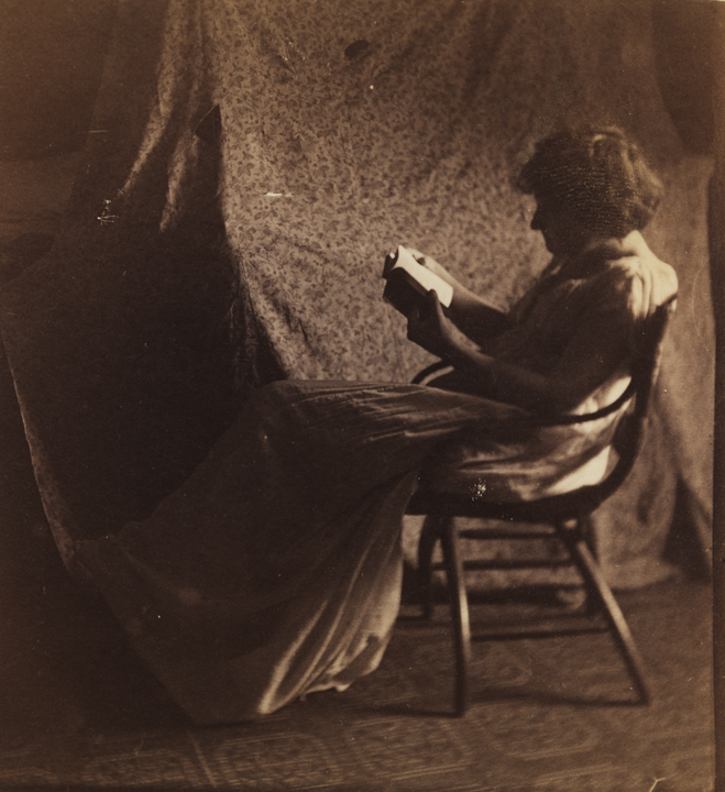 Woman reading in bentwood chair