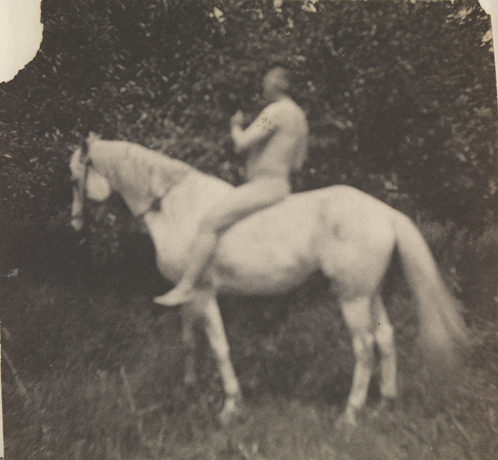 Thomas Eakins nude, facing left, on his horse Billy              