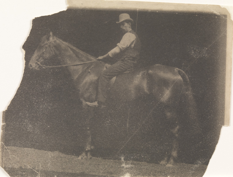 Man in derby hat on horse, facing left