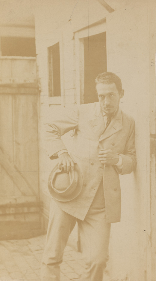 Thomas Eakins leaning against building