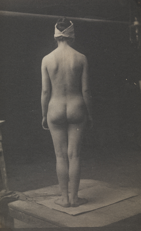 Female nude with mask, from rear