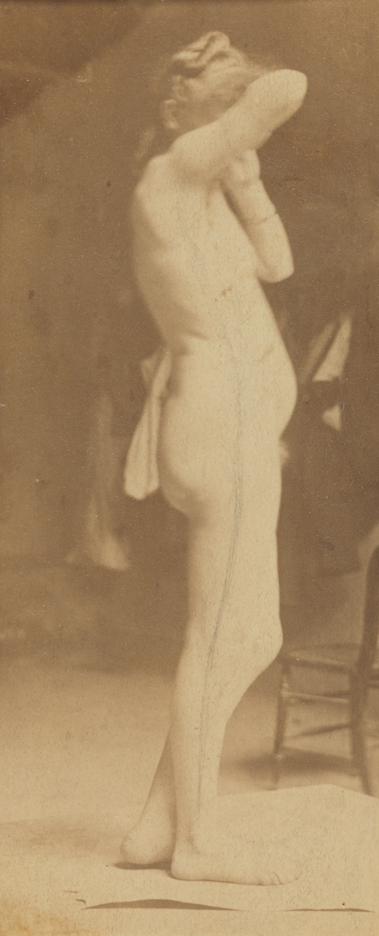 Female nude, facing right, right arm raised, left leg bent