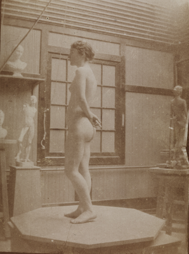 Female nude on octagonal pedestal, facing left in Pennsylvania Academy sculpture studio