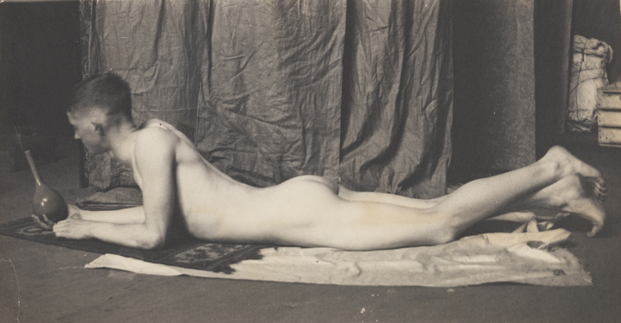 Bill Duckett nude, lying on stomach, holding  vase