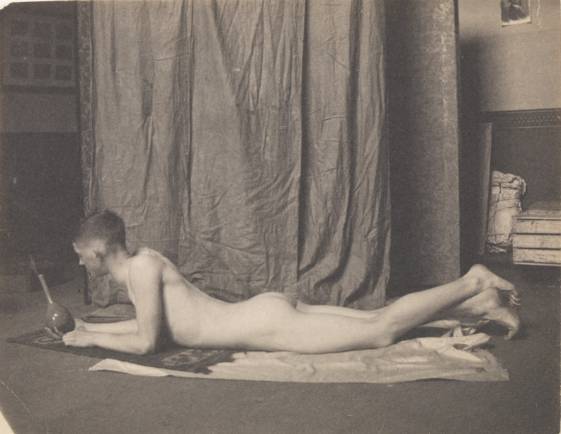 Bill Duckett nude, lying on stomach, holding  vase