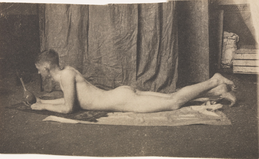 Bill Duckett nude, lying on stomach, holding vase