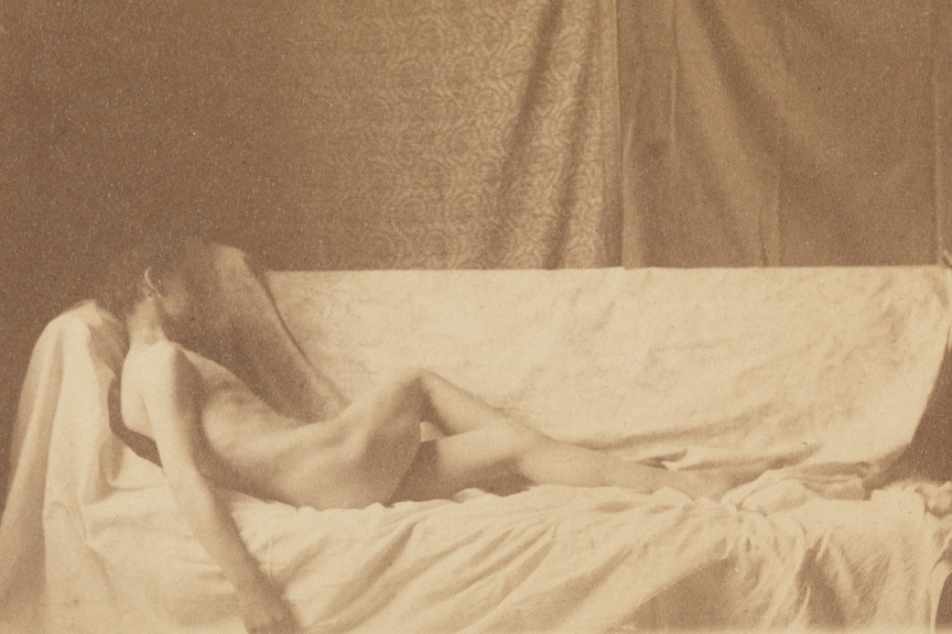 Male nude reclining on draped couch