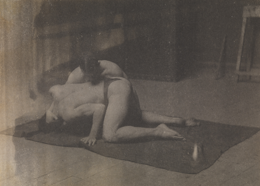 Two males wrestling on floor