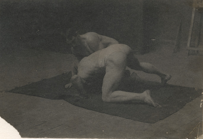 Two males wrestling on floor