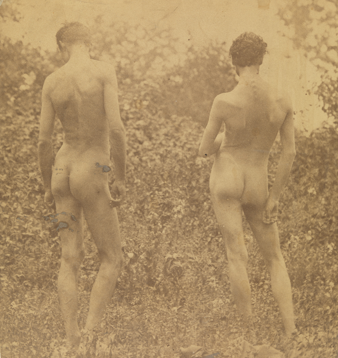 Male nude and J. Laurie Wallace nude, from rear, in wooded landscape