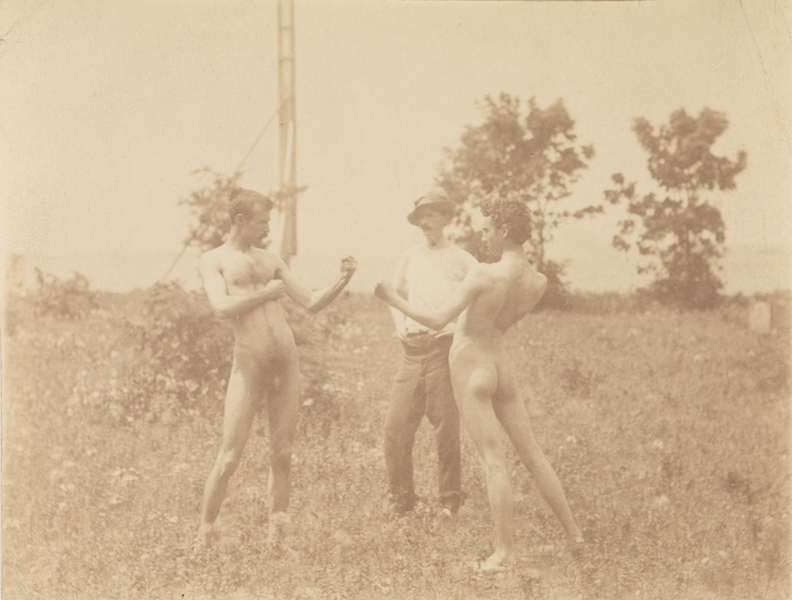 Male nude and J. Laurie Wallace nude, posing as boxers, and male clothed, water in background