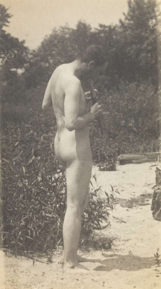 Thomas Eakins playing pipes, facing right