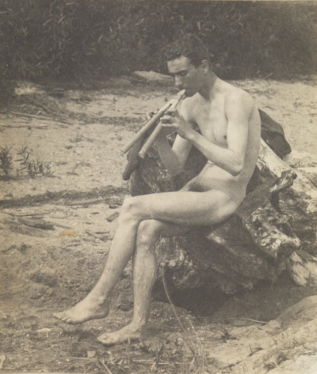 J. Laurie Wallace nude, sitting, playing pipes