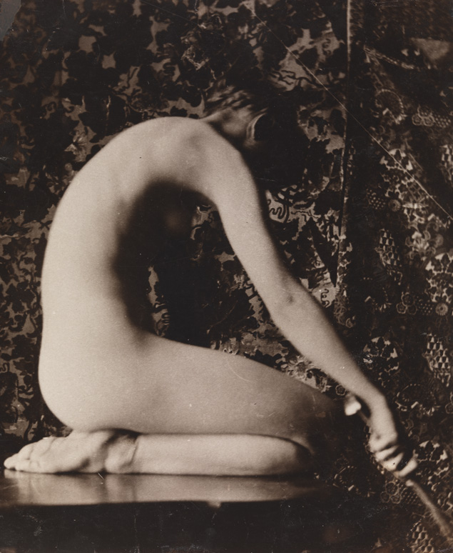 Female nude kneeling on table