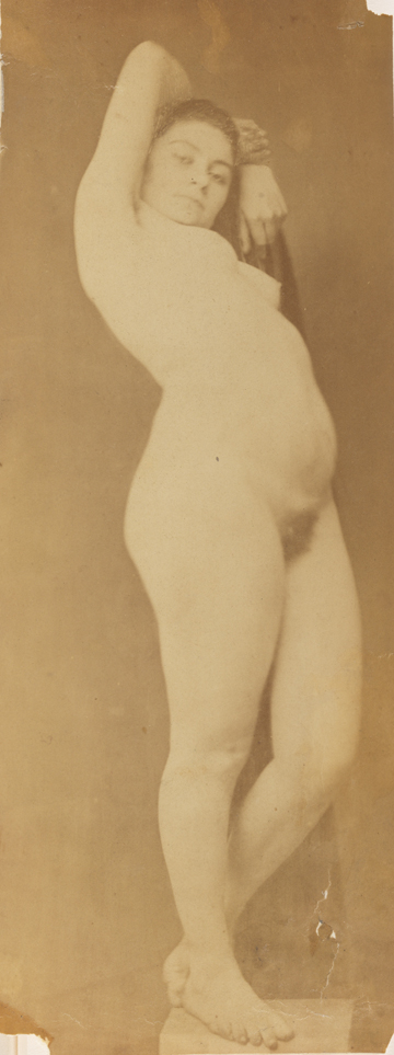 Female nude standing on pedestal, arms raised