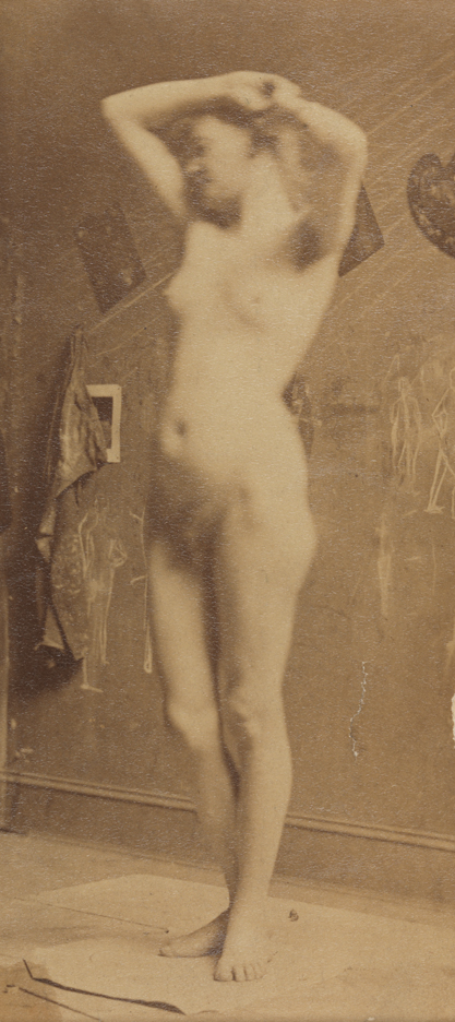 Female nude standing on pedestal, facing slightly left, arms raised                   