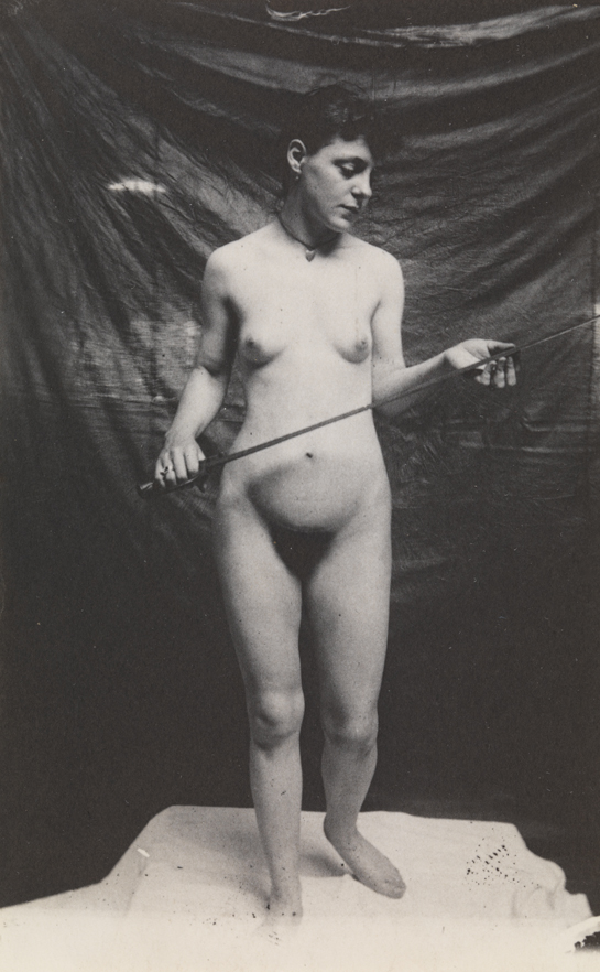 Female nude standing on cloth, with sword