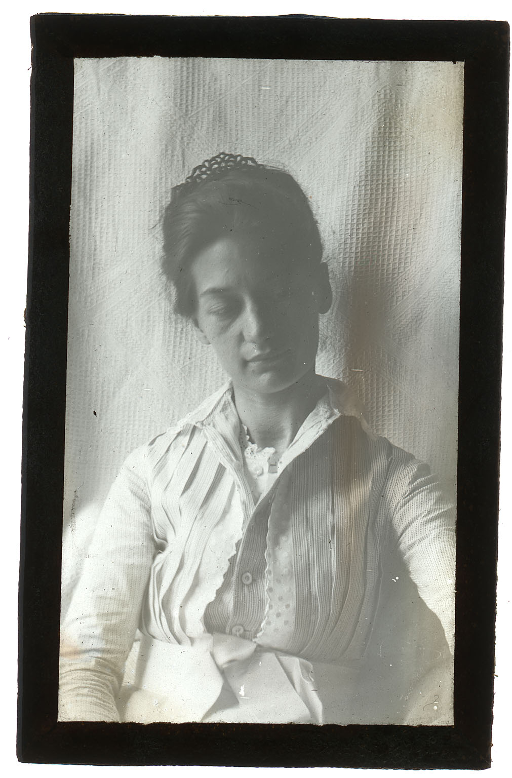 Mary Macdowell in light dress, sitting, looking down