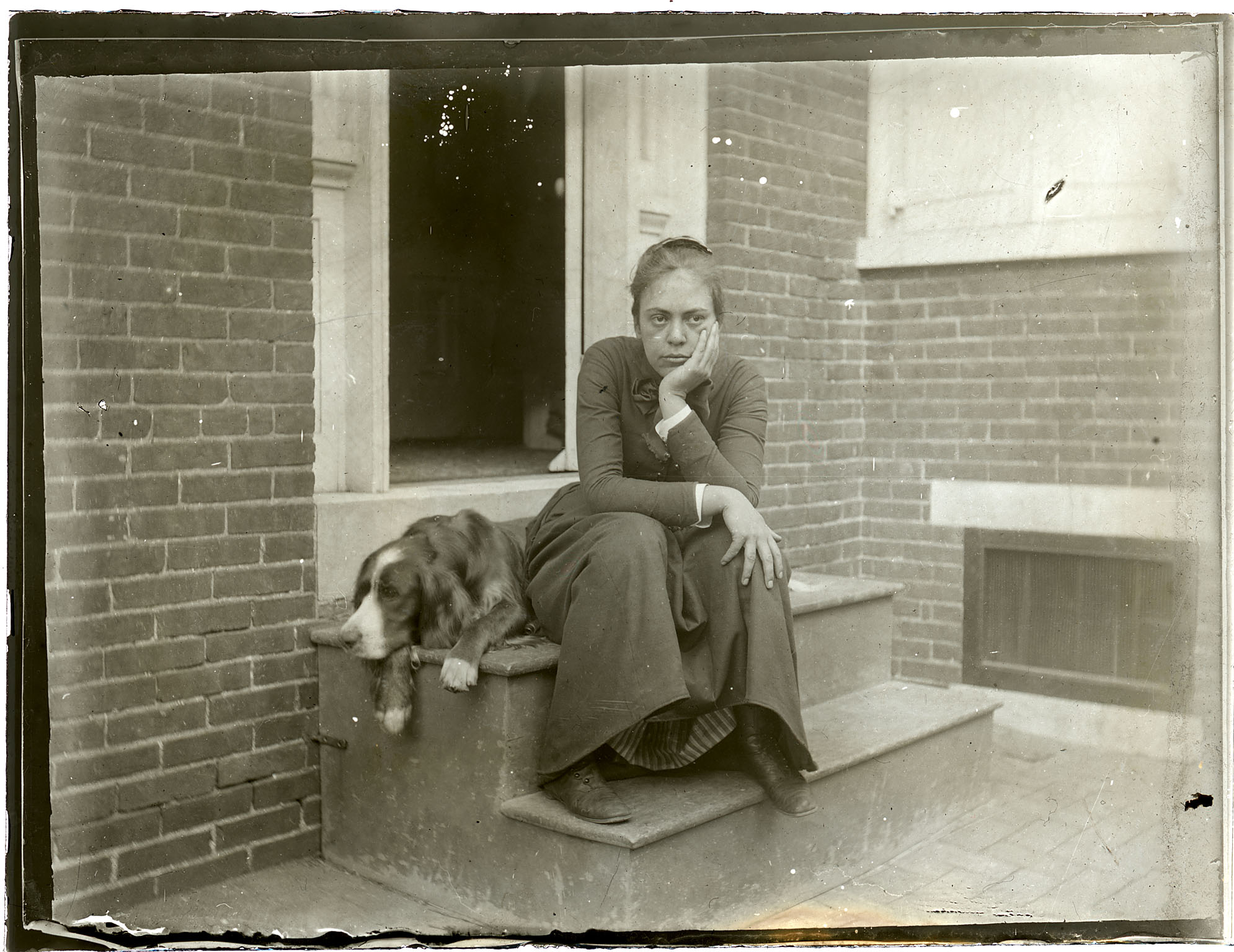 Margaret Eakins and Thomas Eakins's setter Harry on doorstep of the family home at 1729 Mount Vernon Street, Philadelphia